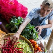 vegetable-stall-sales-manholding-chilies